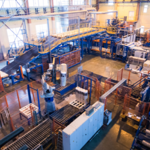 Aerial view of a large, organized industrial facility with conveyor belts and machinery used for processing materials.